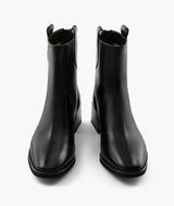 Front view of black lambskin ankle boots with an almond toe