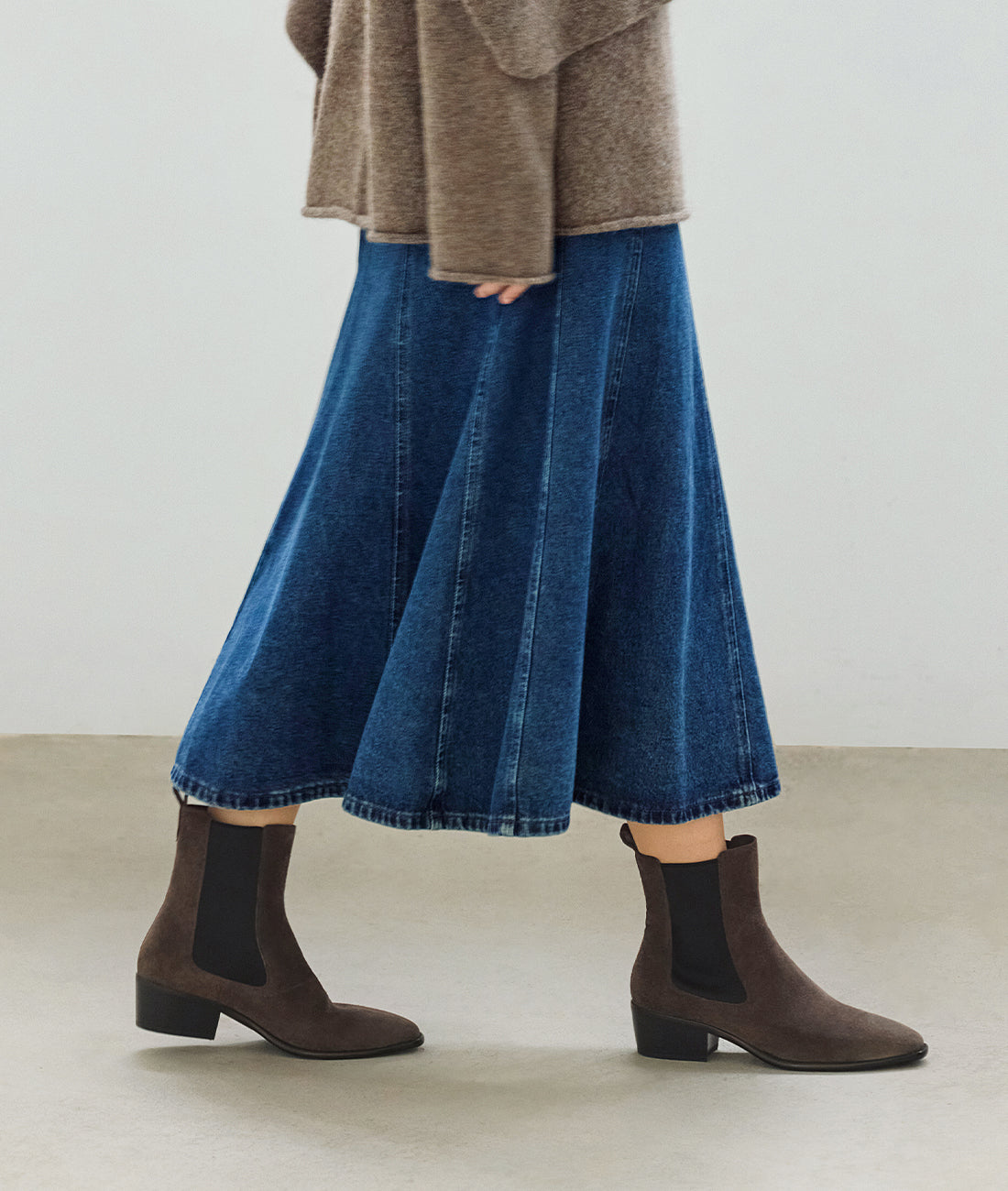 On-foot view of the women's suede Chelsea boots, showcasing the elegant almond toe, block heel, and non-slip sole in action
