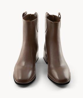 Front view of brown lambskin ankle boots with an almond toe