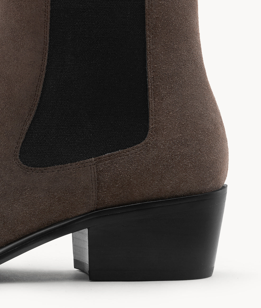A detailed look at the sturdy block heel on these suede Chelsea boots, built for style and all-day comfort