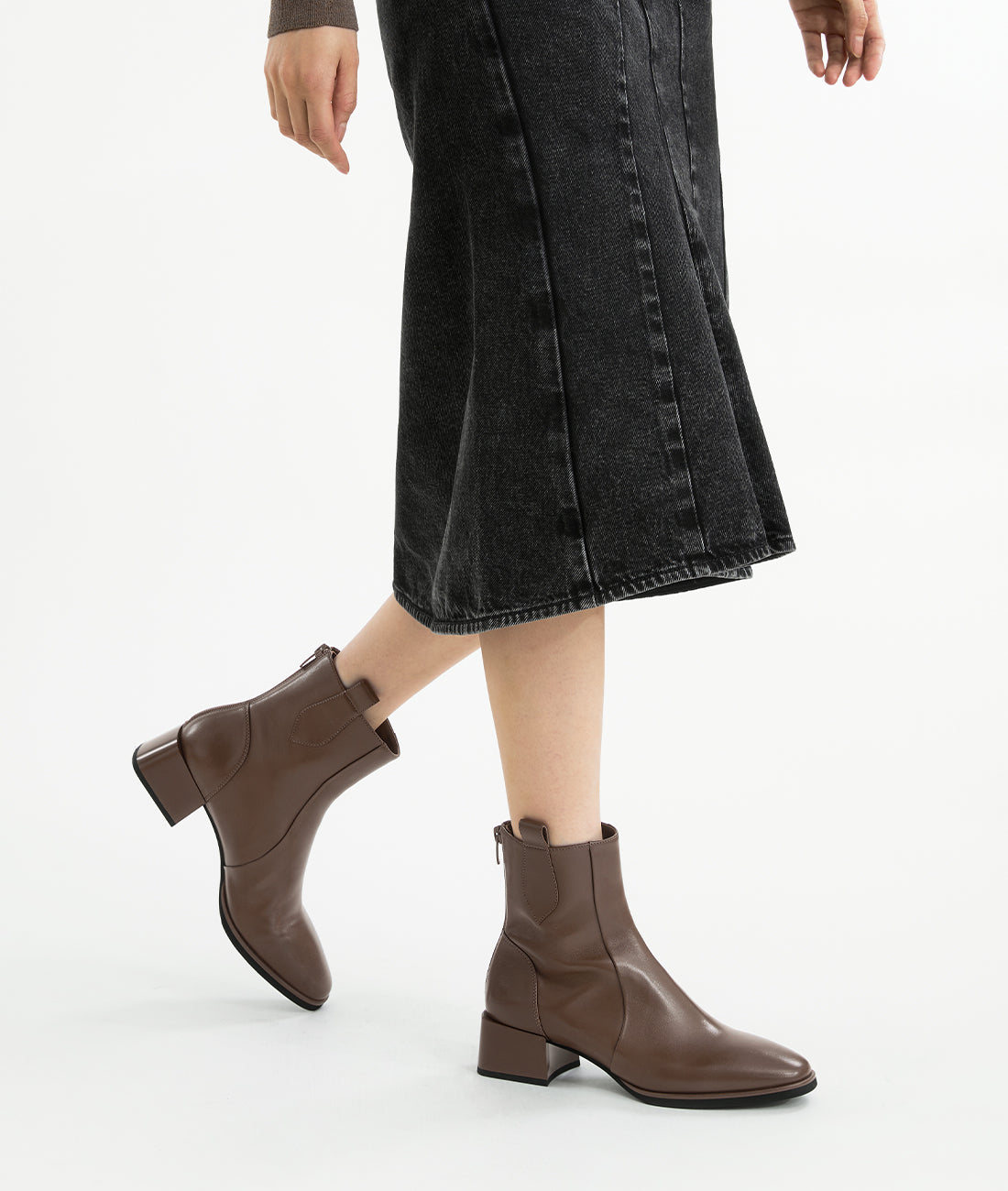 A model wearing the brown lambskin ankle boots with an almond toe and 5cm block heel