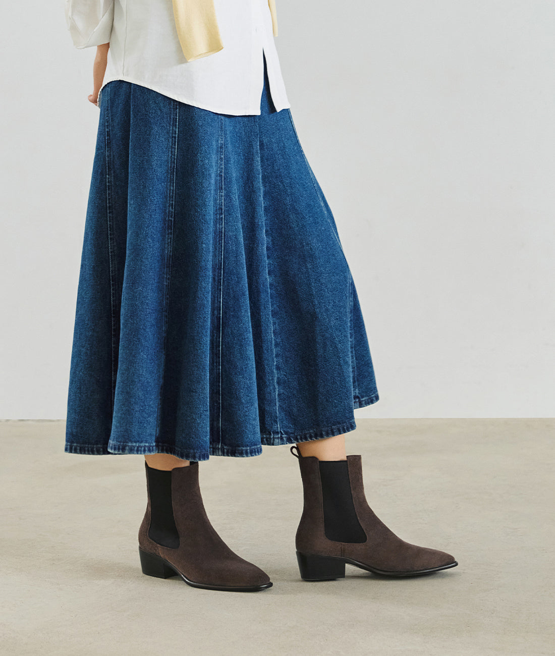 See how these suede Chelsea boots elevate your look, featuring a sleek almond toe and sturdy block heel for versatile style